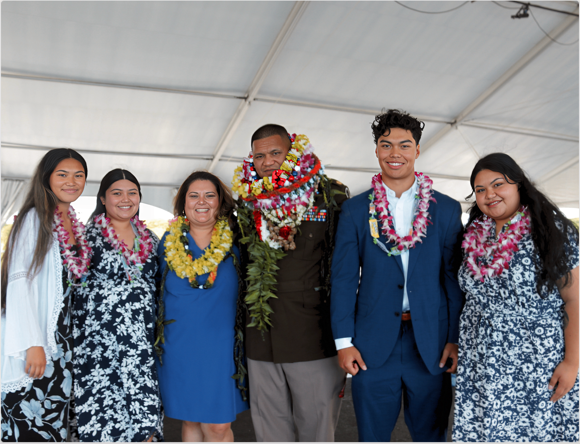 Mumu's family in leis at a graduation ceremony